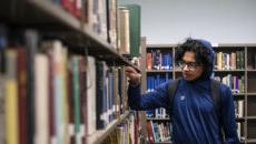 Student browsing books in the library